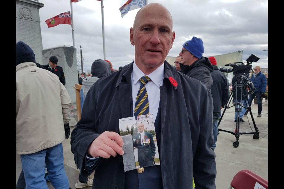 Tim Shaughnessy, president of the Royal Canadian Legion branch in Barrie, shows a picture of his dad that he carried with him to the Remembrance Day service in downtown Barrie today. Shawn Gibson/BarrieToday