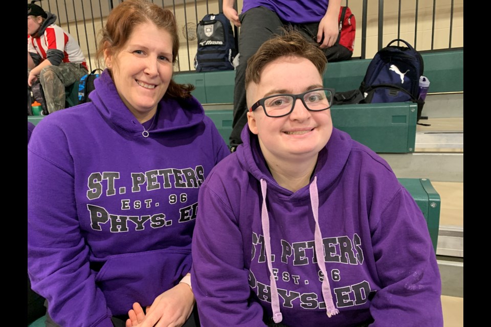 St. Peter's Catholic Secondary School educational assistant Renee Sheremeta and student-athlete Jenny Twigg cheer on the other teams while taking a break from play at a Special Olympics bocce ball tournament at Bear Creek Secondary School on Wednesday.