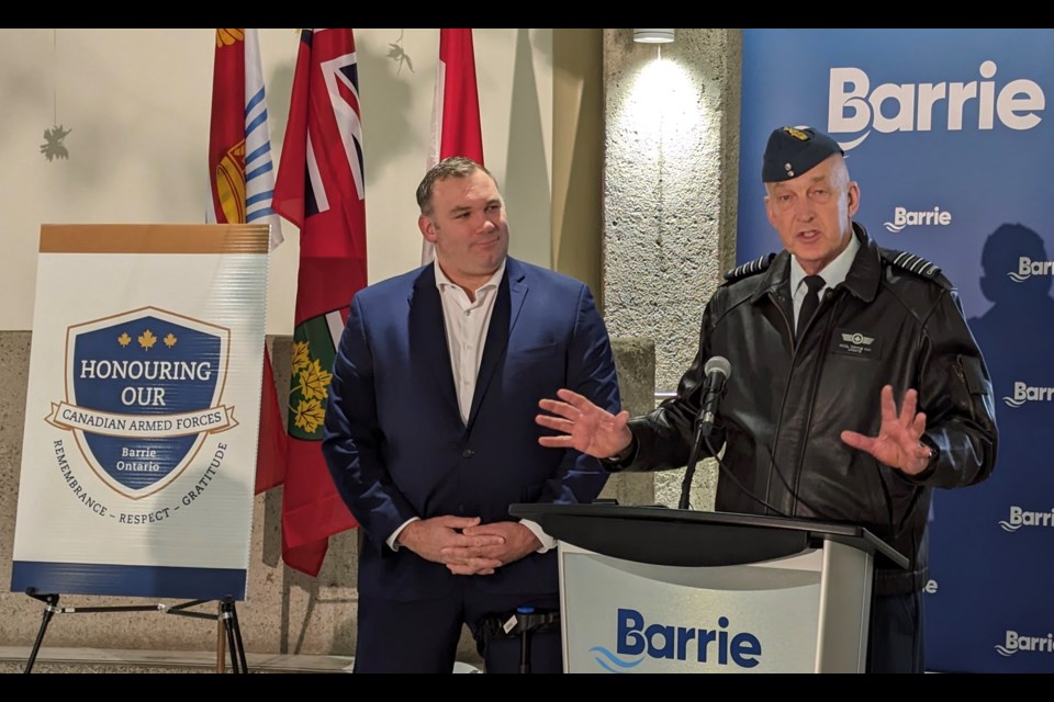 CFB Honorary Colonel Wayne Hay, right, speaks at Barrie City Hall Wednesday while Mayor Alex Nuttall looks on.