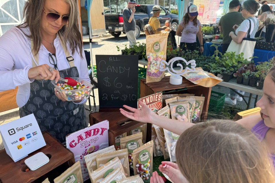 Kerry Weatherbie dolls out some free samples of freeze-dried Skittles during the first outdoor Barrie Farmers' Market of the year.