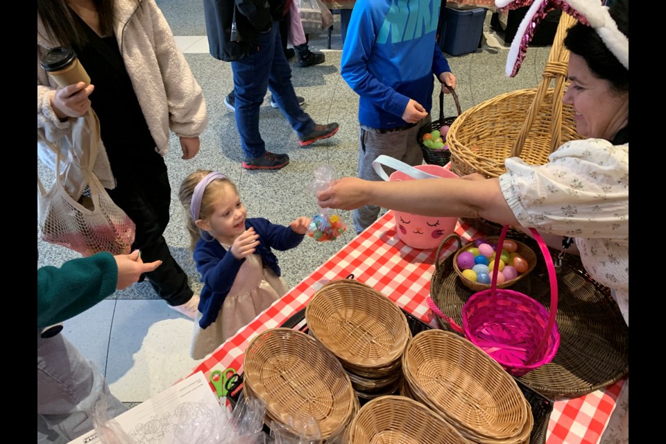 Two-year-old Emma Ferrier trades in the plastic eggs she found during Saturday's second annual Barrie Farmers' Market Easter Egg Hunt for a special treat.
