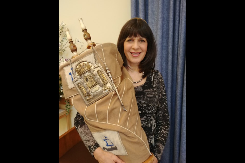 Rabbi Audrey Kaufman, with the Am Shalom Congregation, holds the torah, which will be rededicated during a celebration at the Barrie synagogue on Friday, Aug. 26.
