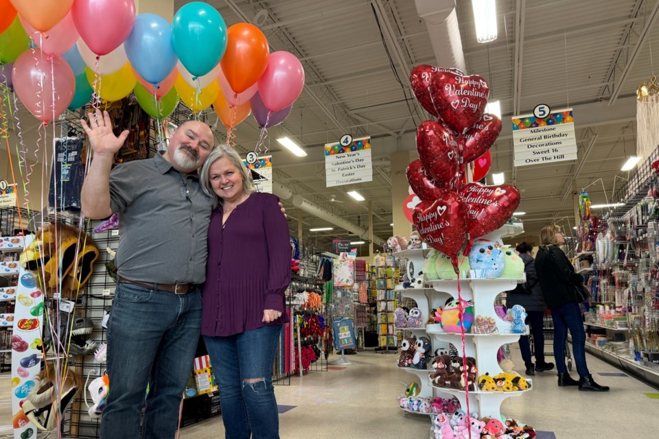 Lori Teed and Brian Tracey, owners of The Party Store in Barrie, wave goodbye to customers as they prepare to retire and close up shop after more than three decades in business.