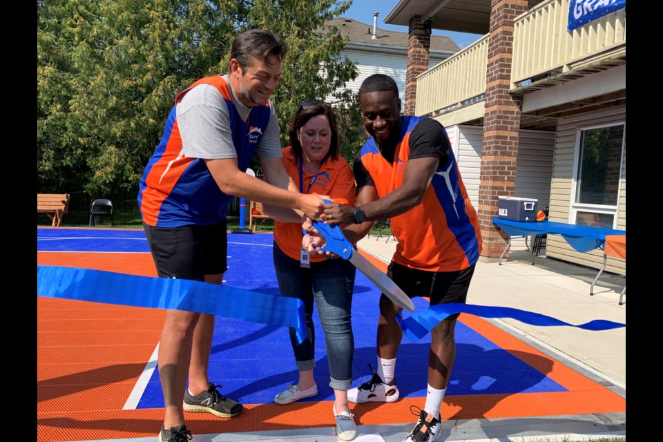 Barrie Mayor Jeff Lehman joined Barrie Housing CEO Mary Anne Denny-Lusk and building service manager Roderick Robinson at the official ribbon-cutting for the organization's new Community Recreation Complex Basketball Court, Friday afternoon. 