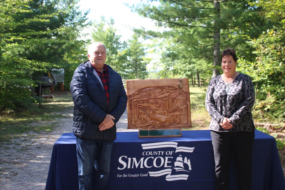 Simcoe County Warden George Cornell and Donna Lacey, a representative with the Canadian Institute of Forestry, are shown Saturday at the Simcoe County Museum.