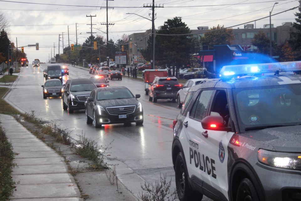 A hearse carrying the body of South Simcoe police Const. Morgan Russell is escorted along St. Vincent Street on its way to his funeral at the Sadlon Arena on Oct. 20.