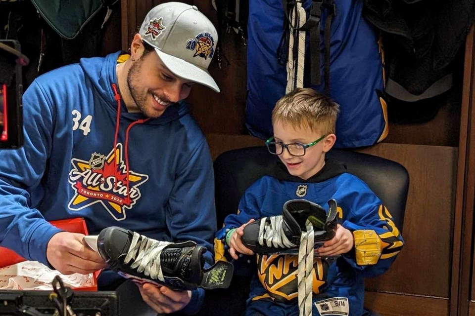 Toronto Maple Leaf centre Auston Matthews and Barrie's Finn Sposito admire the design they created together for the 2024 NHL All-Star Weekend.