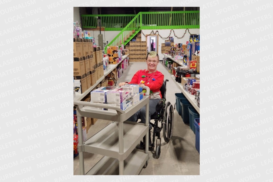 Dakota, a volunteer with the Simcoe Muskoka Family Connexions Holiday, works to sort and organize donations. 