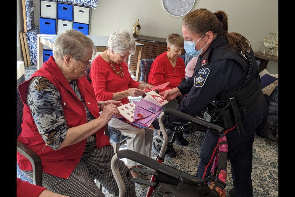 Barrie police Const. Julie Reynolds hands out Valentine's Day cards Tuesday. 