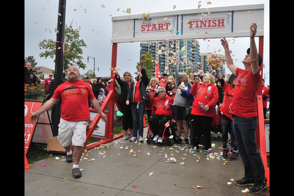 The Terry's Team of cancer survivors were the first group out of the gate at the Terry Fox Run in Barrie, Sunday morning. Throwing flower pedals in the air were Randy Greengrass, left, run chairman Michael F. McDougall. Ian McInroy for BarrieToday