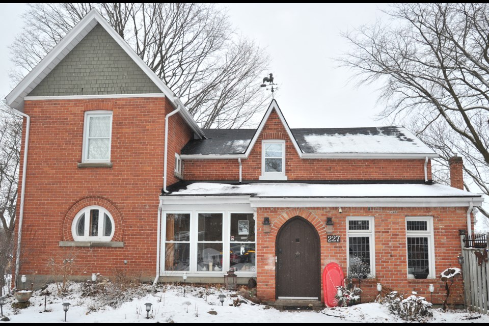 A three-quarter round original stained glass window and a cathedral-framed main door are featured in this St. Vincent Street home. Ian McInroy for BarrieToday