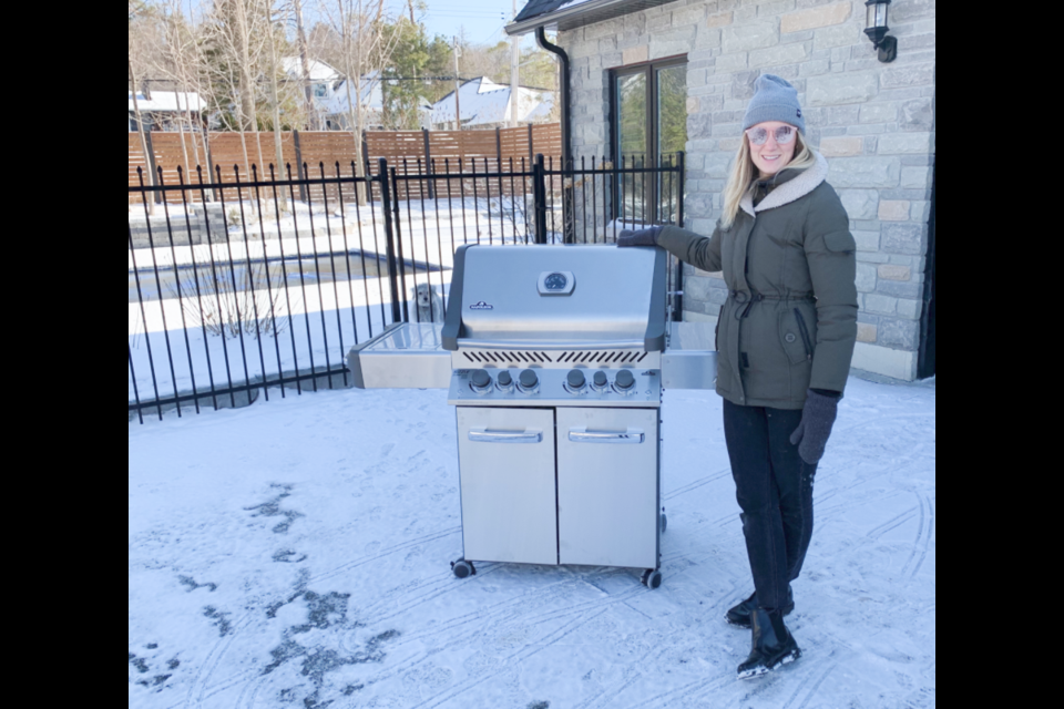 Oro-Medonte Township resident Victoria, who didn't want her last name used, stands beside her new barbecue, installed by Napoleon Home Comfort, after thieves stole hers. Photo supplied