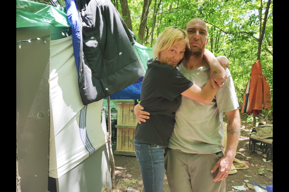 Robert and his girlfriend Khristina stand beside their tent in what's referred to locally as Milligan's Pond. Authorities will be evicting them and anyone else in park area beginning Thursday morning. Shawn Gibson/BarrieToday