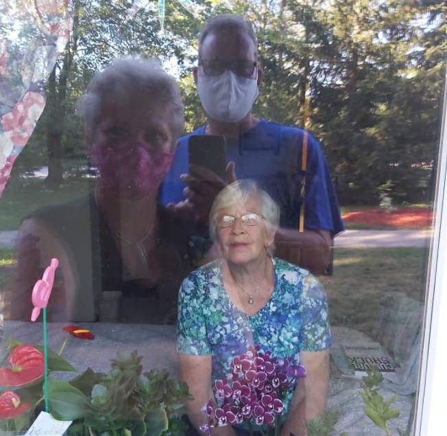 Jane Fokkens says hi to family from the inside of her Roberta Place long term care ground level room. 