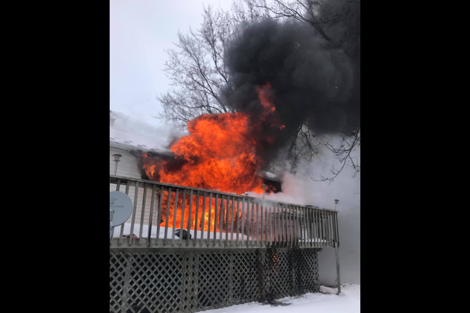 Flames and smoke billow from an Innisfil home on 2nd Line in February 