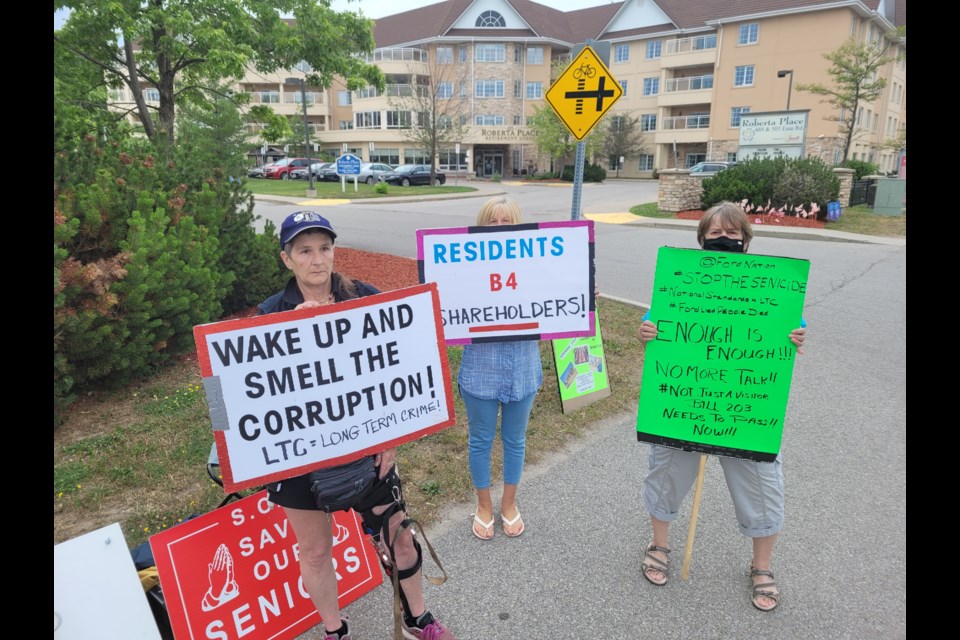 From left, organizer Sparky Johnson, Julie Farrell and Cheryl Spelliscy stand outside Roberta Place in south-end Barrie on Friday afternoon. They say they are fighting for better treatment for residents in long-term care homes.