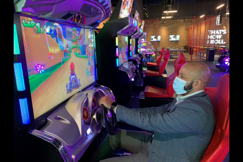 Kashif Ahmad, executive director of amusement and entertainment for Cineplex, enjoys one of the nearly 100 games available to play at The Rec Room in south-end Barrie.