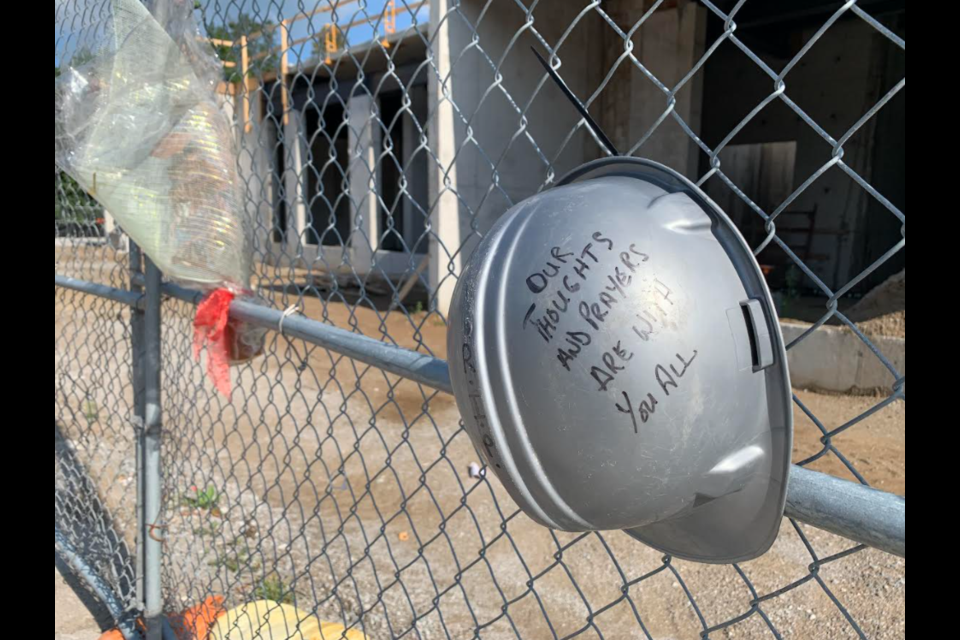 This file photo shows a memorial placed at the Dunlop Street West construction where 52-year-old Corey Phillips was killed June 24, 2021. 