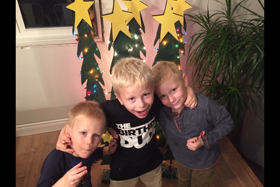 Noah, Quentin and Liam Moreau show off the handmade Christmas trees they made to raise money in order to purchase toys for a local holiday toy drive. 