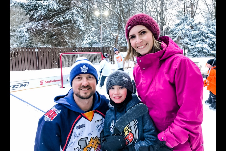 Brad, Jack and Courtney Davidson enjoy some outdoor family time at their backyard rink in Midhurst.