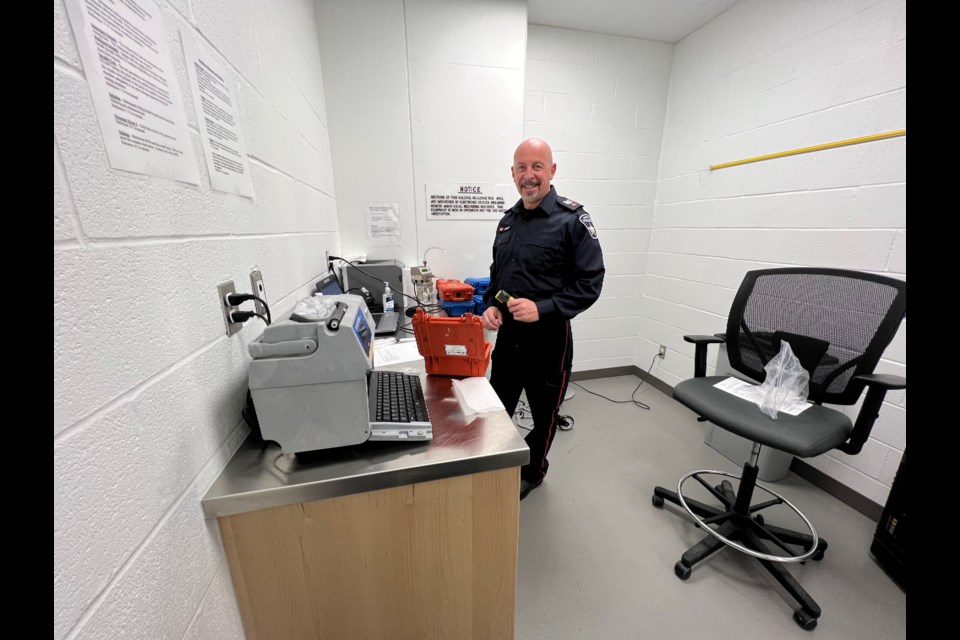 Acting Sgt. Patrick Morrow, with the Barrie police traffic unit, prepares some gear which officers use when they stop suspected impaired drivers.