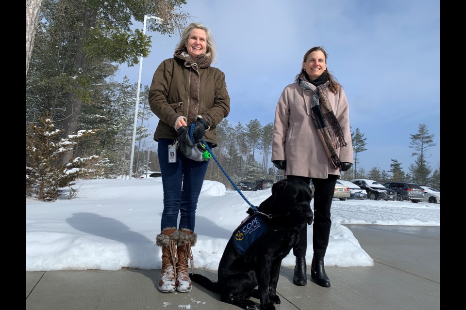 Jane Boake founder of Canine Opportunity, People Empowerment (COPE) and school Superintendent. Charlene Scime, along with COPE Service Dog Henry, are excited about the partnership between the Simcoe Country District School Board and COPE to run the organization's Canine's in the Classroom program. 