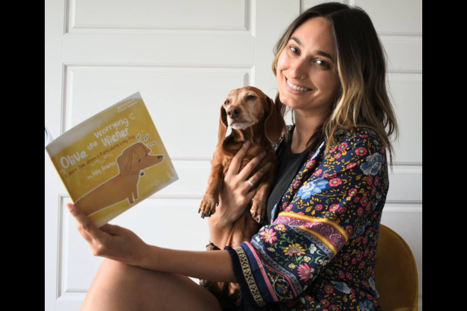 Ally Arena recently won a bronze medal in the pre-school picture books category in the U.K.-based Wishing Shelf Book Awards for her first book titled Olive the Worrying Wiener : A Short Tale about a Particularly Long Dog.