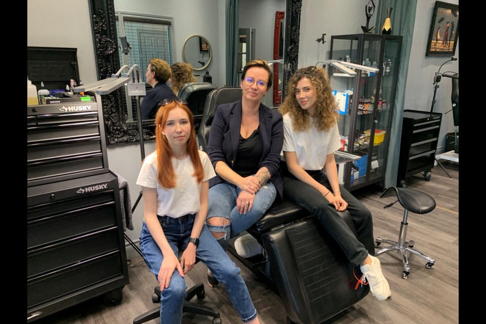 Daria Montague (middle), owner of Rebel Girl Ink in Barrie welcomed Ukrainian refugees Julia Kholiavchuk (left) and Julia Liverinova (right) after they were forced to flee due to the war in their home country.