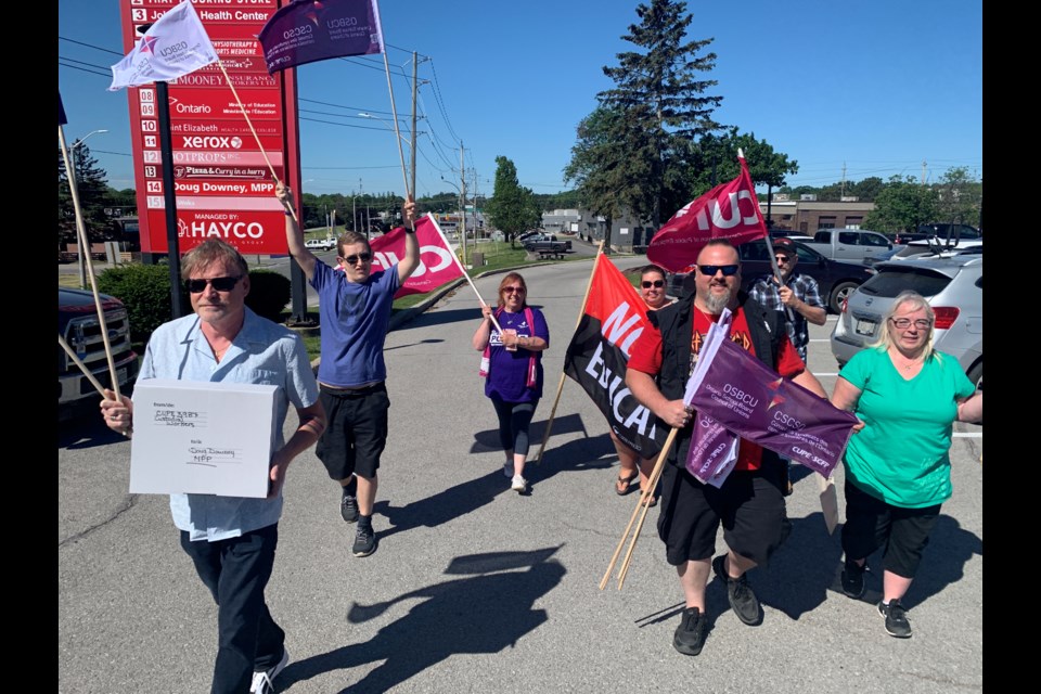 Members of CUPE locals 3987, 1310 and 4340 gathered at the Bell Farm Road office of Barrie-Springwater-Oro-Medonte MPP Doug Downey on Thursday.