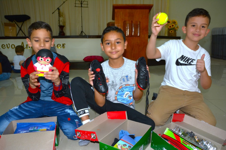 Children in Costa Rica check out their Canadian-packed Operation Christmas Child shoeboxes