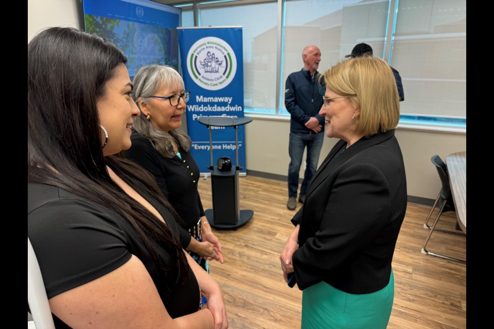 Health Minister Sylvia Jones, right, speaks with Germaine Elliott, executive director of the Mamaway Wiidokdaadwin Primary Care Team, and one of <a href=