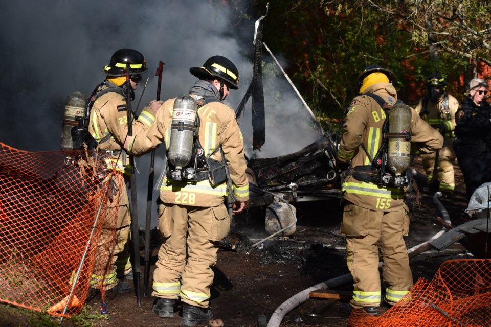 Barrie firefighters at a John Street encampment Thursday morning.