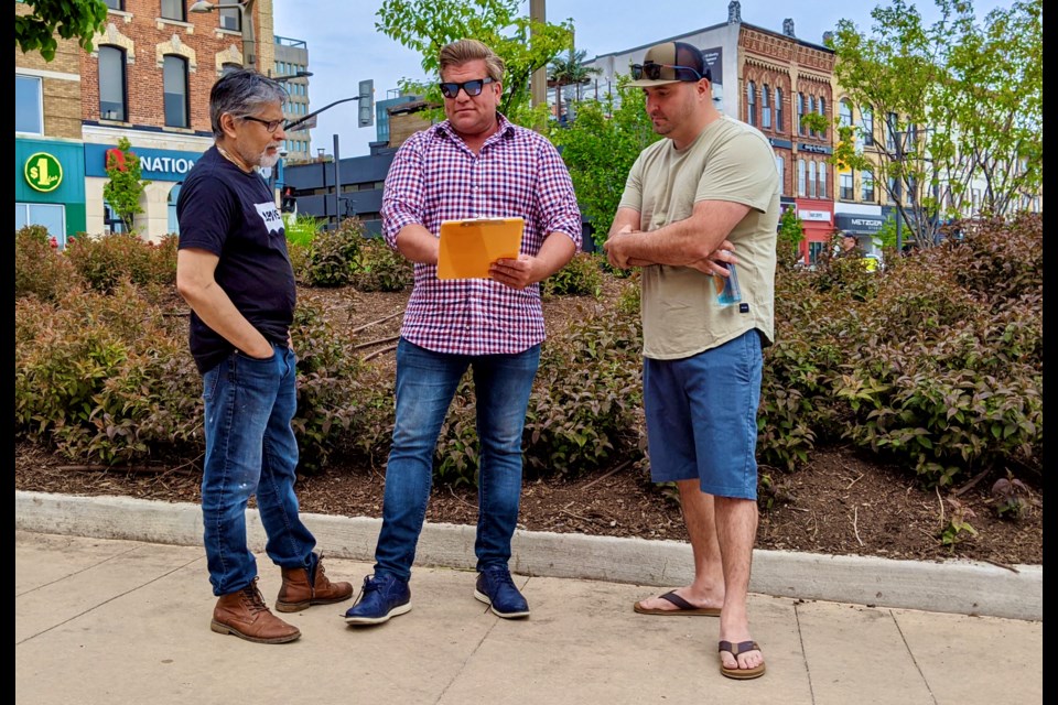 Barrie Coun. Mike McCann (middle) speaks with Dimuthu Perera, left, owner of Andro Cakes, and Stefano Agostino of P_ZZA, in downtown Barrie near Memorial Square about a survey on ‘Is Downtown Barrie Safe and Inviting’.