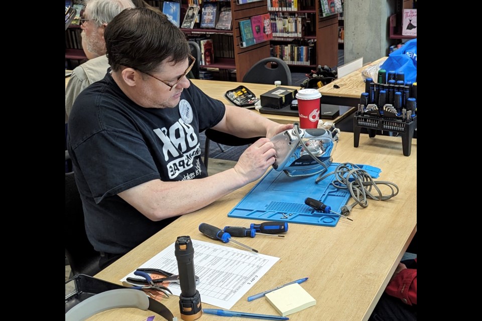 Brian McGillis works on an iron at the Repair Café on Saturday morning at the Barrie Public Library.