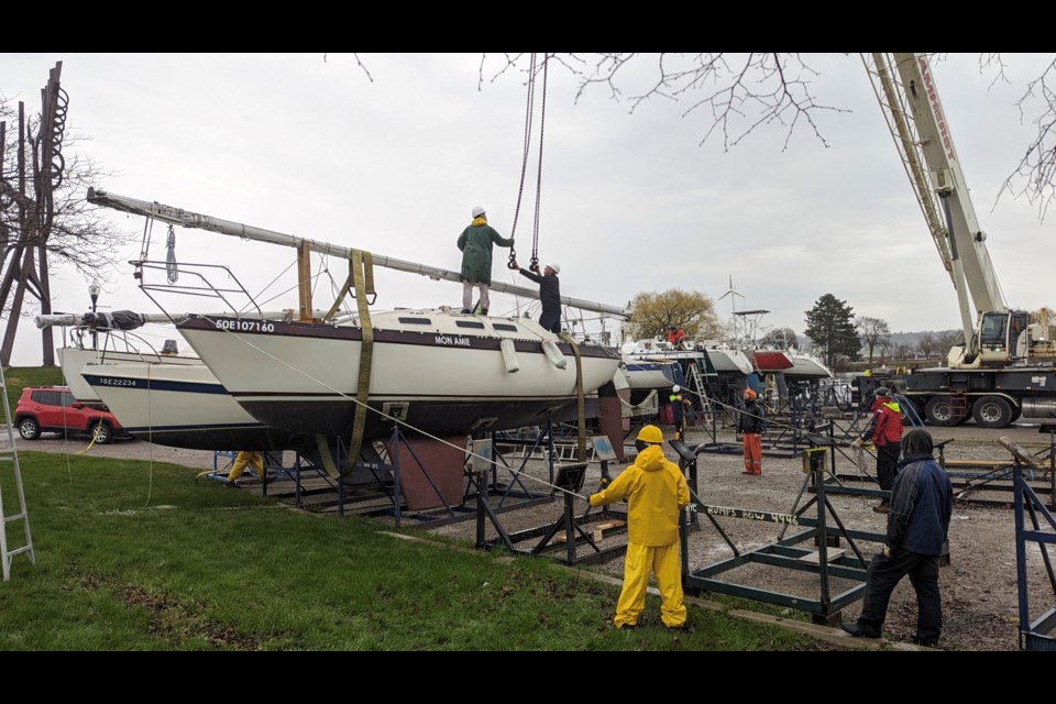 Sailboat about to be lifted into Barrie Marina water.