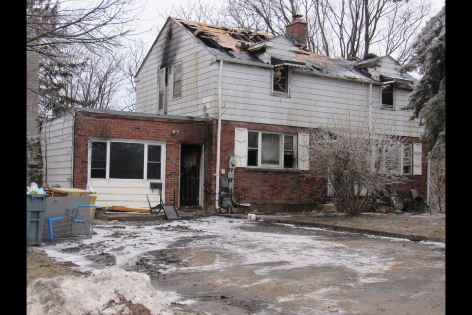 The house at 54 Sunnidale Rd., is shown the morning after a fire ripped through the house, leaving one resident dead.