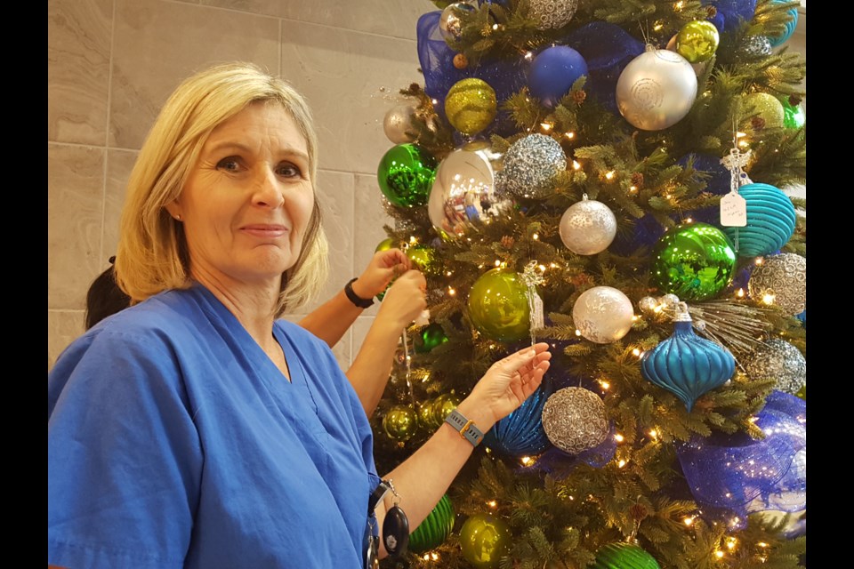 Linda Sansom hangs an angel on the RVH's Angel Tree, Wednesday Nov. 27, 2019. Shawn Gibson/BarrieToday