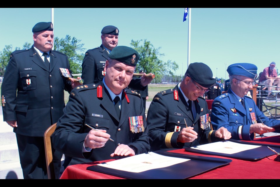 New base commander Colonel Liam McGarry (left) signs documents along with outgoing base commander Brigadier-General Carl Doyon (right)
Robin MacLennan/BarrieToday