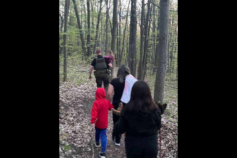 A family is led to safety after becoming lost in the woods of Ardagh Bluffs on Saturday just before dusk.