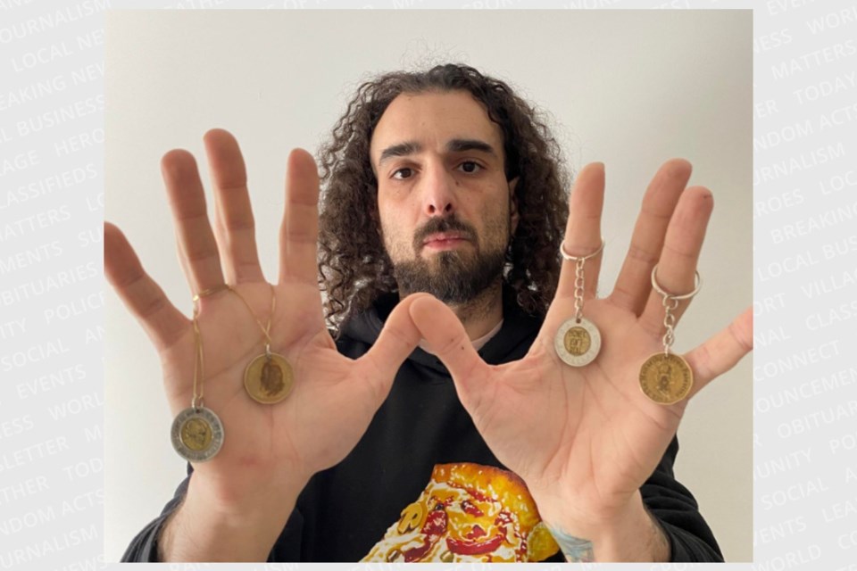 Khaled El-Kurdi shows some of the coins that have led to him being charged for defacing Canadian currency.