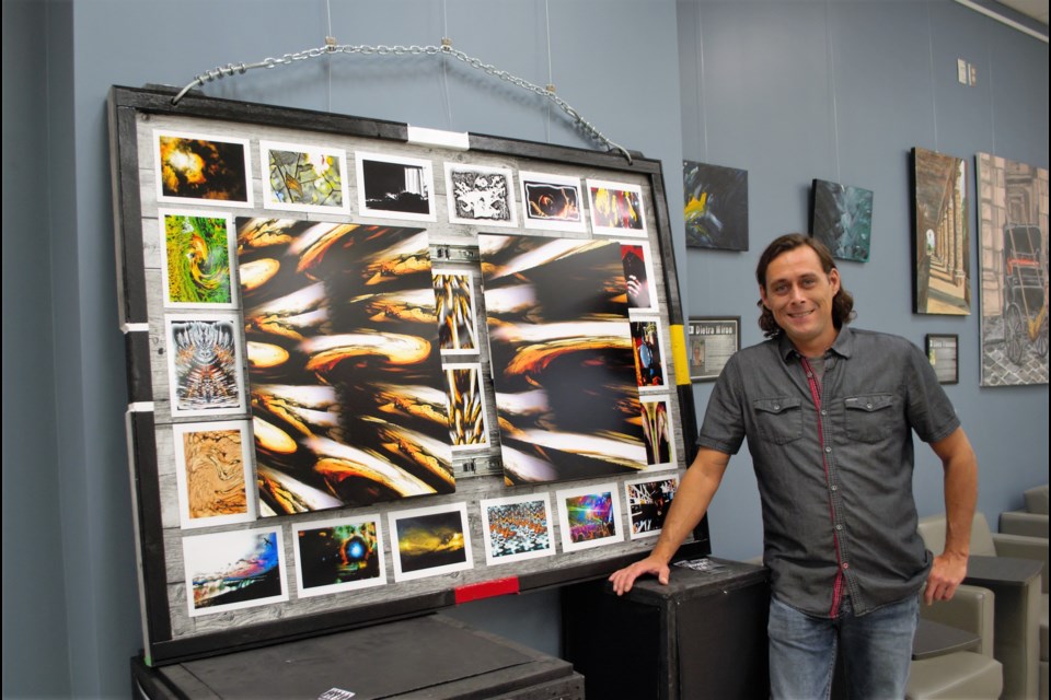 Tyler Shepperdson poses with his art piece, which is abstract photography. Jessica Owen/BarrieToday