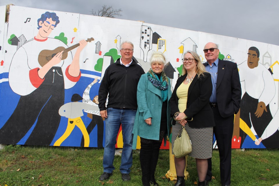 As part of the City of Barrie's Artist At Work program, a new mural was highlighted at the corner of Bayfield and Sophia streets on Wednesday, Oct. 23, 2019. From left are Brian Tamblyn from the Coral Housing Group board of directors, Coral Housing Group president Tina Grant, City of Barrie director of Creative Economy Karen Dubeau, and Coral Housing Group vice-president Douglas Shaw. Raymond Bowe/BarrieToday