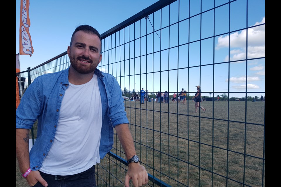 Kris Barclay stands outside the fence to the main stage where he used to watch the stars shine. Now, he is part of the lineup at Boots and Hearts. Shawn Gibson/BarrieToday
