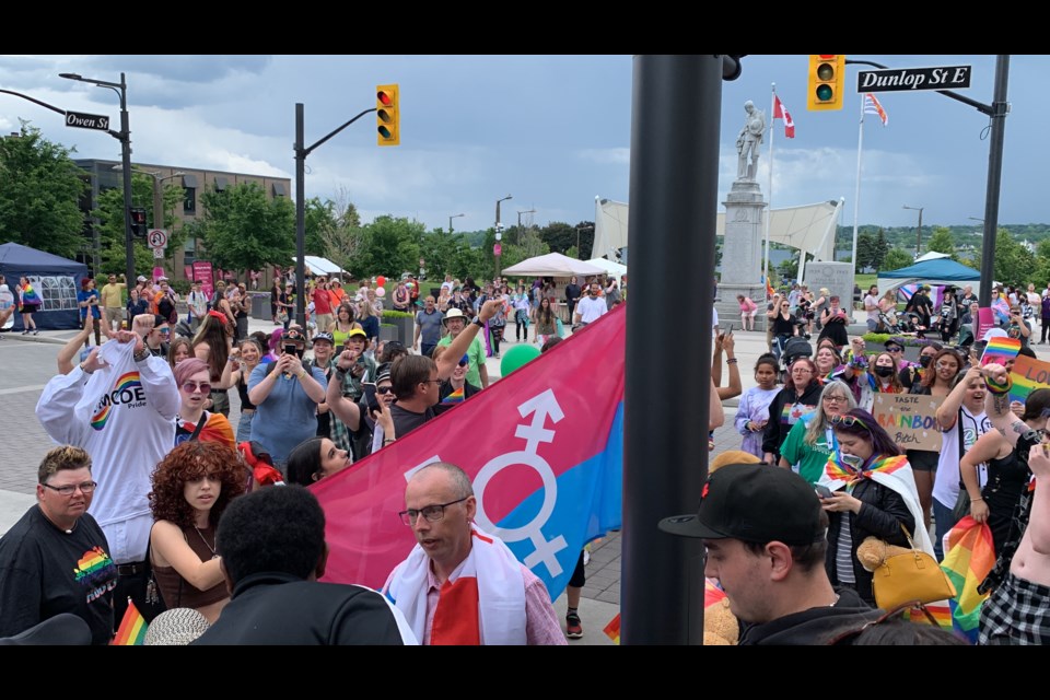 The crowd at Saturday's Pride parade begins to chant "love is louder" after two men attempted to interrupt the festivities in downtown Barrie. 