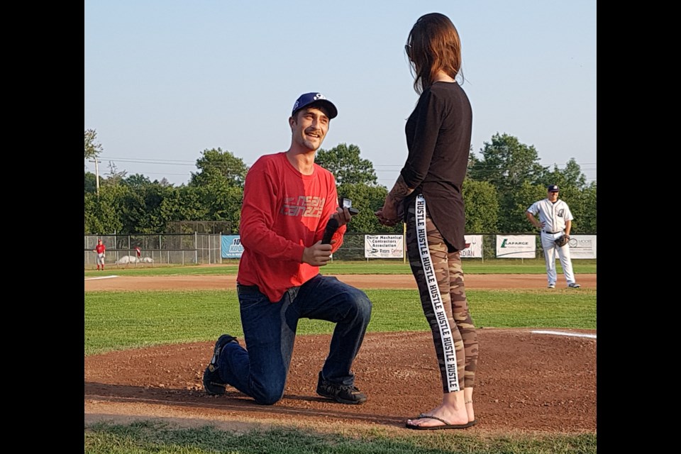 Norm Casquenette and girlfriend Angela Gerrish threw out the first pitch at the Barrie Baycats game Thursday night. And then Norm got down on bended knee to proposed to Angela. Shawn Gibson./BarrieToday