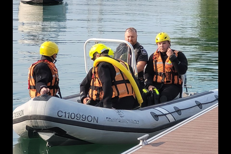 Members of the Barrie Fire water rescue team get ready to head out into Kempenfelt Bay on Thursday.