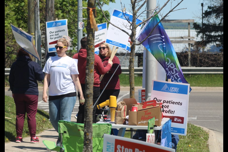 People opposed to Bill 60 and the privatization of Ontario health care protest outside Royal Victoria Regional Health Centre in Barrie on Wednesday, May 17. 