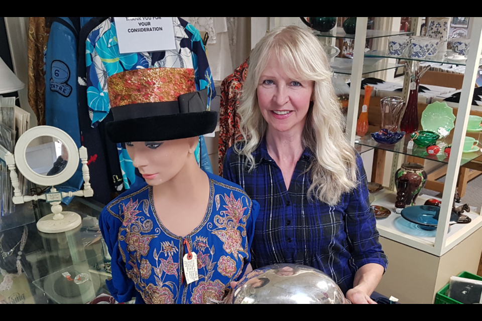 Lesia Tomko shows off some of the antiques that can be found at the reopened Sanford and Son on Innisfil Street. Shawn Gibson/BarrieToday