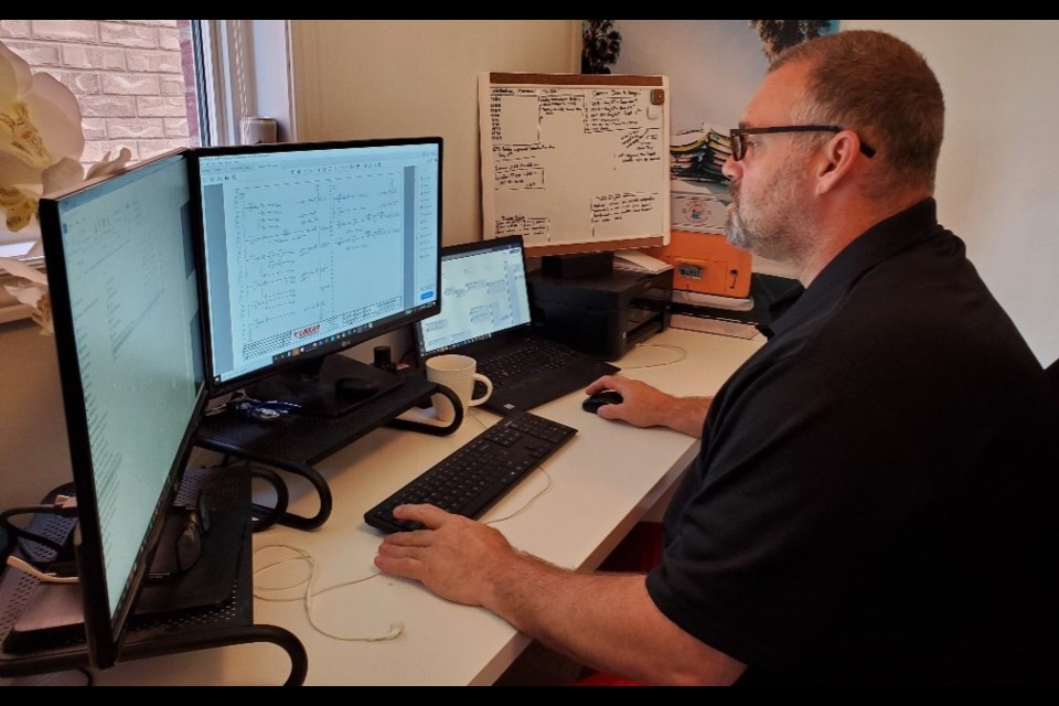 Brent Piercy, an electrical engineering supervisor at Barrie's Linear Transfer Automation, is shown working from home. Contributed photo