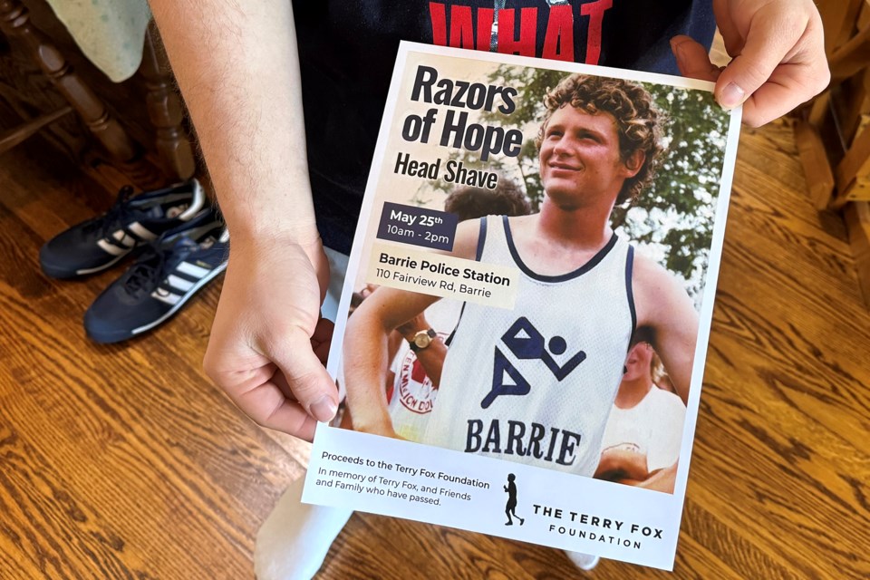 Jason Helmond shows off the poster for his sixth annual Razors of Hope event in support of the Terry Fox Foundation on May 25 at Barrie police headquarters on Fairview Road in Barrie.